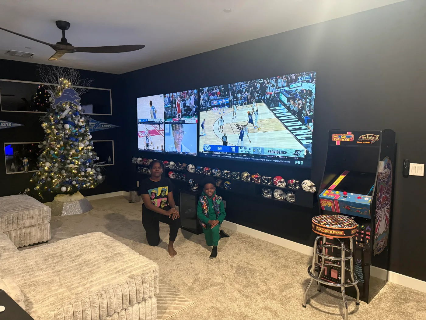 Game room with a wall of screens and an arcade cabinet