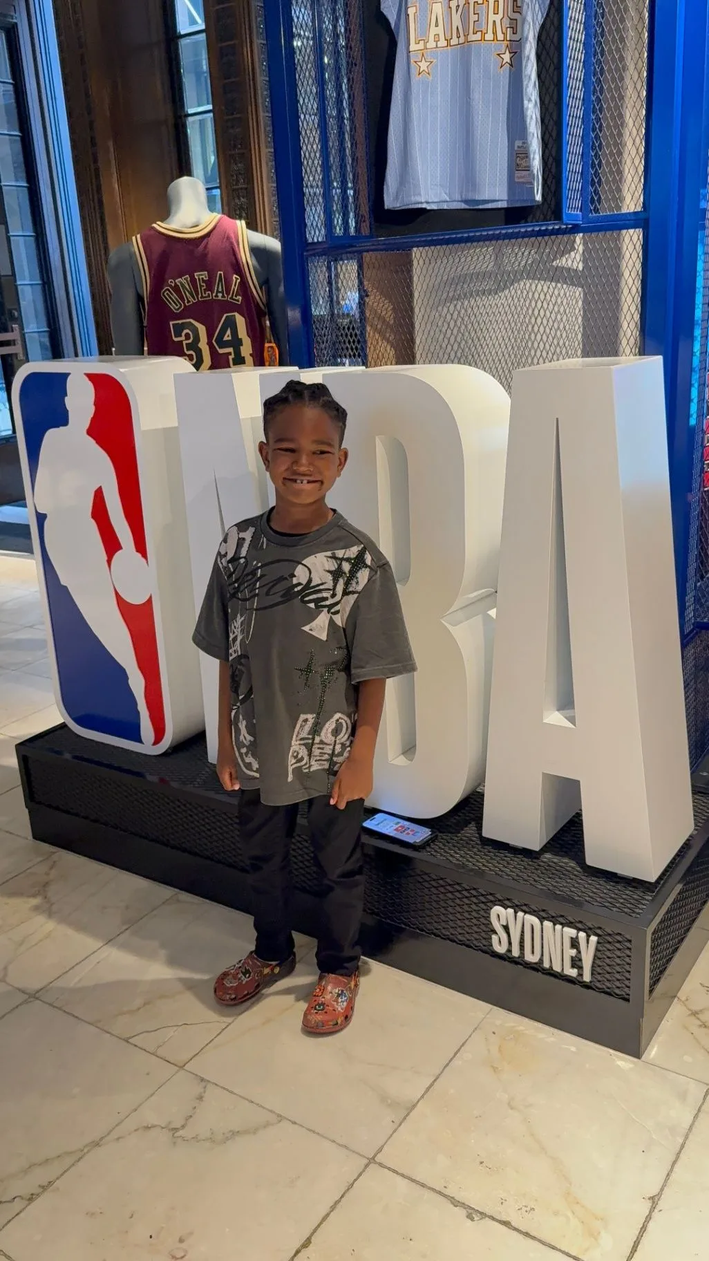 Cruz standing beside a large NBA display in Sydney